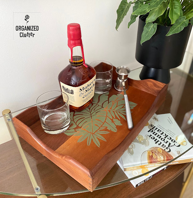Photo of an upcycled vintage mid century/modern boho beverage tray with tropical leaf stencil.