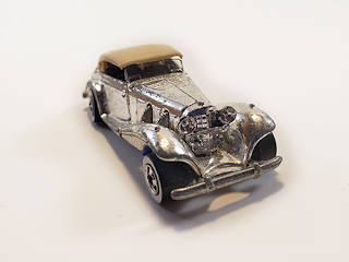 A silver 1937 Mercedes 540k with the Hot Wheels logo embossed in the hood