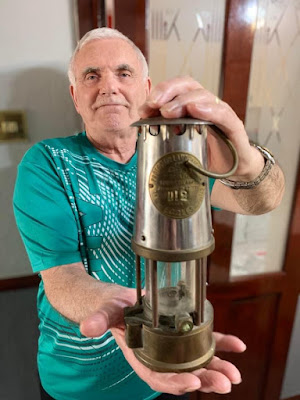 Ken holding up his oil lamp