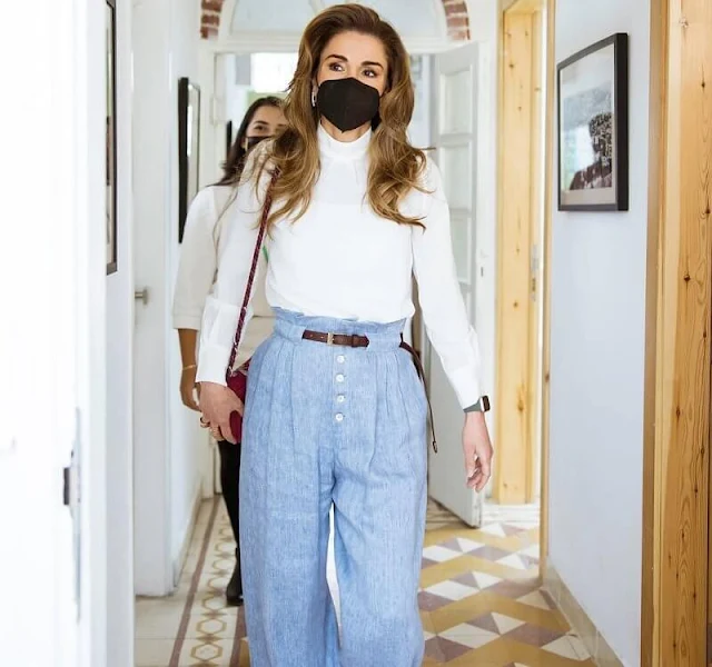 Queen Rania wore light blue front button high waist linen blend wide leg pants, and a white high neck silk blouse