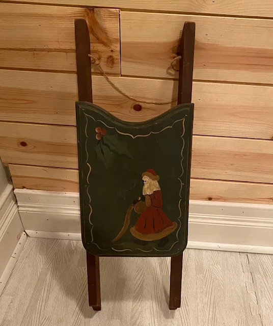 Photo of a small dated decorative sled from Goodwill.