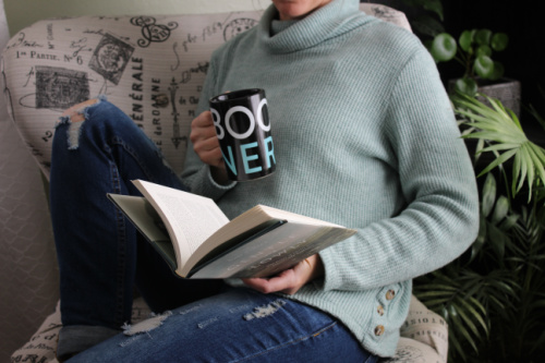 Reader holding a Book Nerd Cup