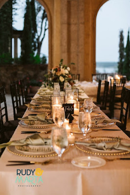 bella collina atrium reception table with white linen and clear gold studded chargers