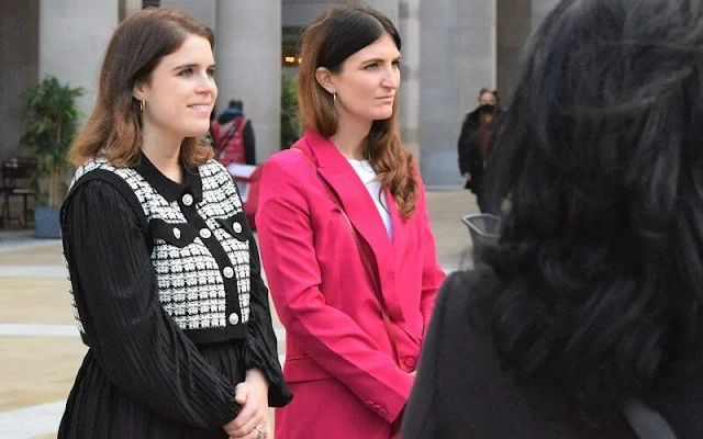 Princess Eugenie wore a black pleated dress with tweed cardigan short jacket from Oscar De La Renta, and black, knee-high boots