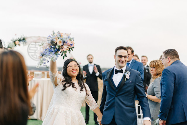 bride holding bouquet in the air after ceremony ends