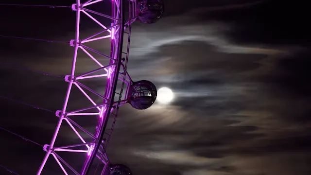 A Harvest Moon rises behind the London Eye in 2020. Credit: PA