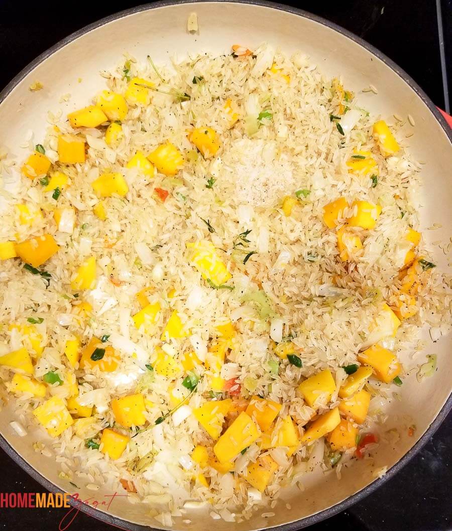 Adding rice to pot to make pumpkin rice