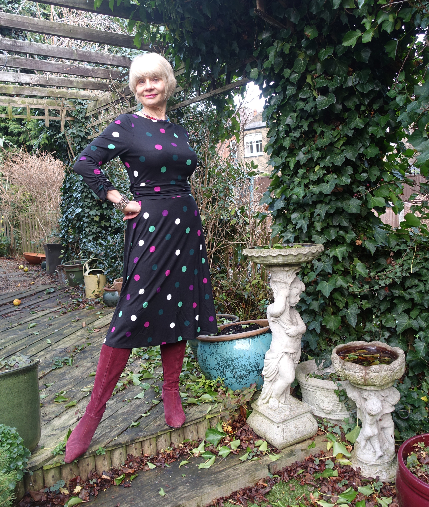 Ruching on the waist and sleeves makes this Hobbs dress figure flattering. Gail Hanlon from Is This Mutton adds long boots and a winter seasonal necklace that echoes the colours of the polka dots