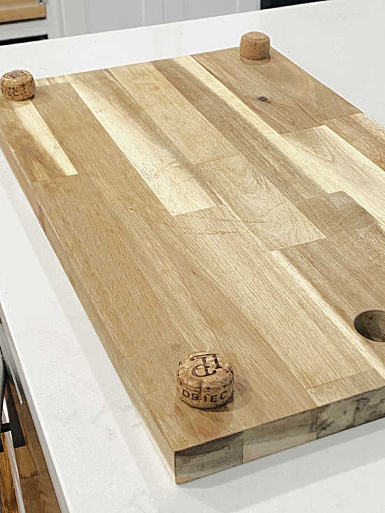 champagne cork feet on cutting board