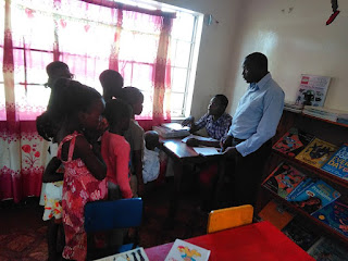 https://commons.wikimedia.org/wiki/File:Librarian_teaching_the_children_on_how_to_read_aloud.jpg