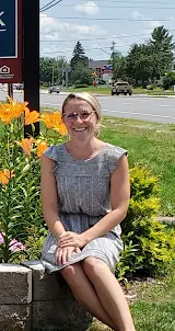 Samantha, Resident Services Coordinator, sitting outside of Amherst Park