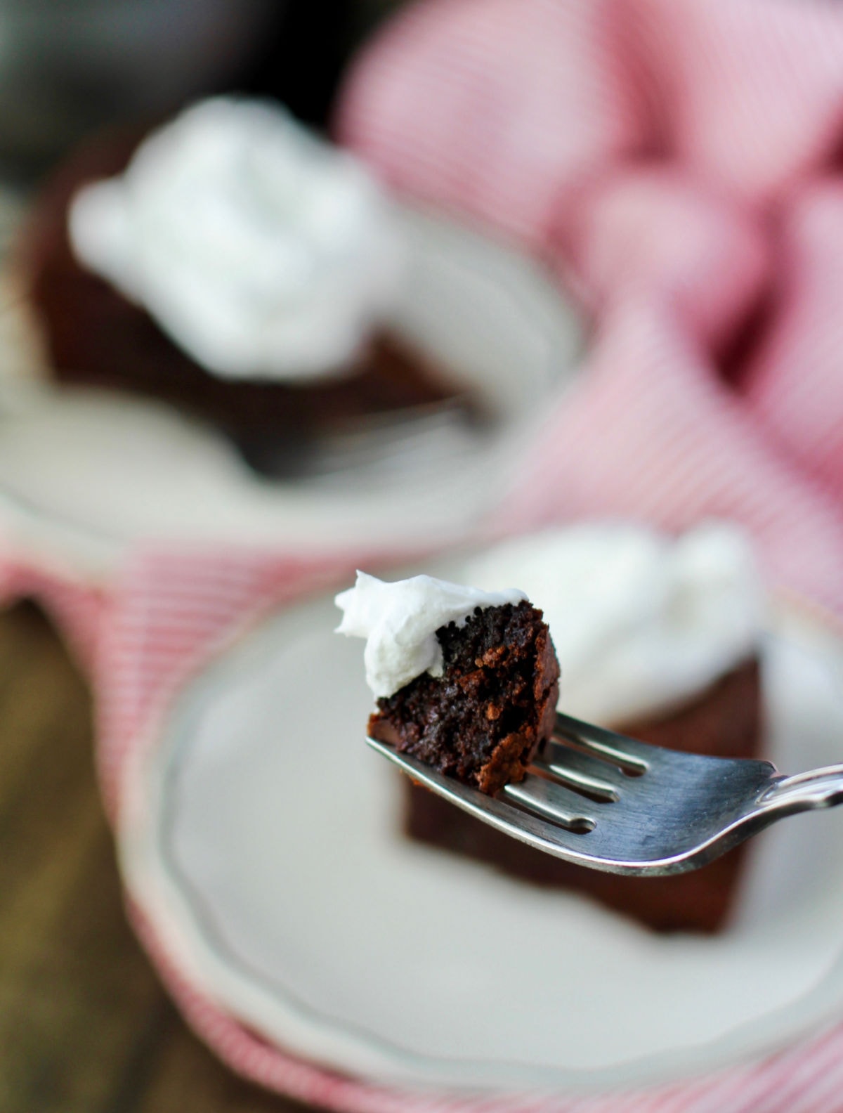 Chocolate whiskey cake with whipped cream bite.