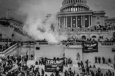 black and white photograph of Trump rioters with Trump flags on steps of the US Capitol,  https://www.monroegallery.com/gallery/default/photoDetail/5-07-45-pm-january-6-2021-us-capitol-washington-dc#:~:text=5%3A07%3A45%20PM%2C%20January%206%2C%202021