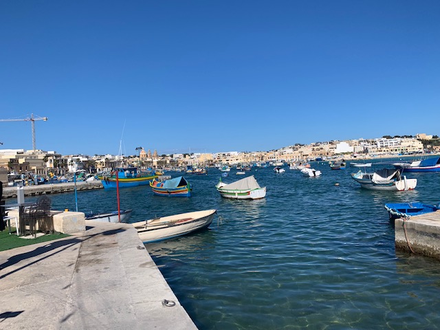 View over Marsaxlokk harbour, with traditional Maltese fishing boats