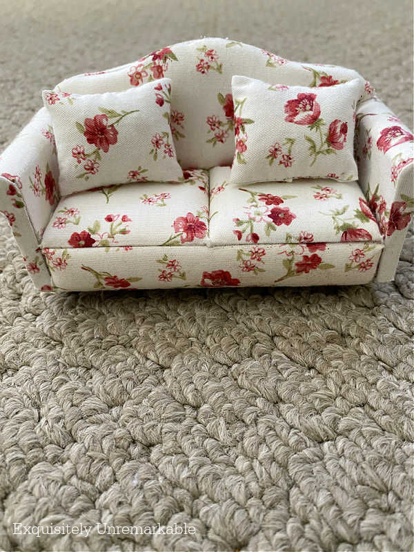 Miniature Floral Sofa on green carpet flooring