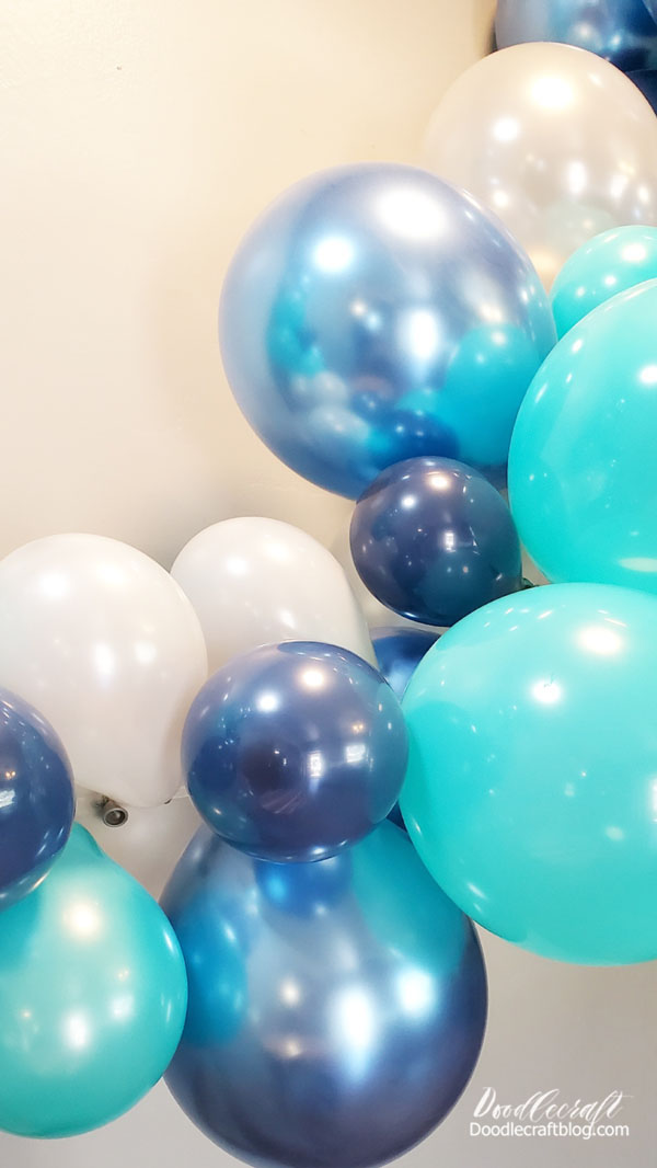 Step 3: Hang up the Balloon Garland! Then use the plastic balloon chain to hook it right on a command hook on the wall. This makes it a breeze to transform your own house into a party backdrop--with super easy clean up too!