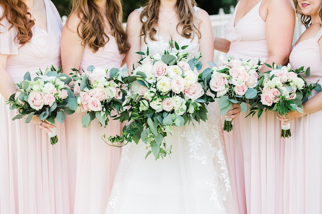 bride and bridesmaids in pink holding bouquets