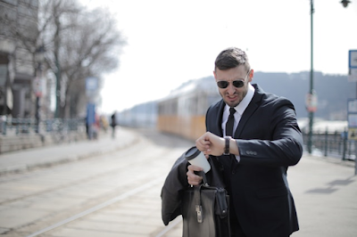 A Modern Man Wearing Black Suit and Holding Black Leather Bag
