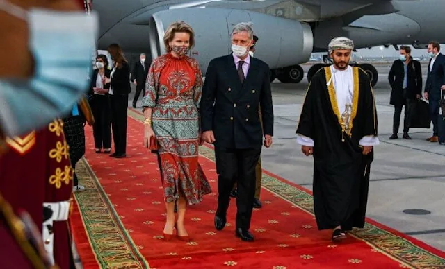 Queen Mathilde wore a new multi ataraxia ruched crepe dress from Johanna Ortiz. The Sultanate of Oman and the United Arab Emirates