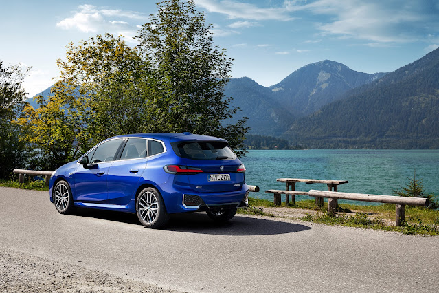 The 2022 BMW 2 Series Active Tourer captured in a nice lake and mountain scenery. The  2 Series Active Tourer is parked near by two or three benches with a nice view to the lake and the hills.