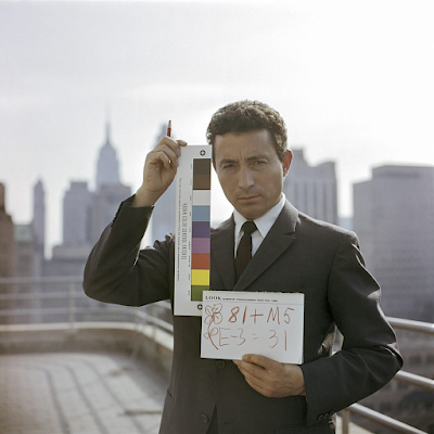 color photograph of Tony Vaccaro holding a film test strip in NY, 1960