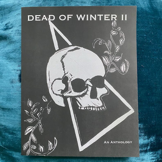 A black book with a skull, vines, and the words "DEAD OF WINTER II: Milk and Cake Press" on the cover