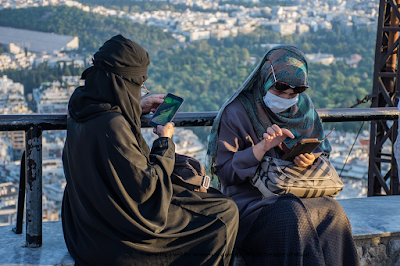 wearing a veil for women or a cap for men at the time of Shalat