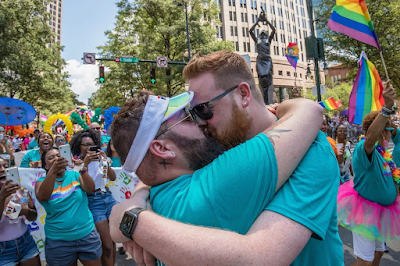 two men kissing at a 2019 Charlotte Pride event