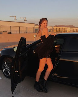 Ellie Thumann posing for picture with the car