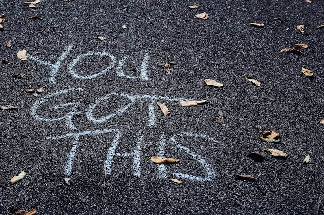 Road with 'You've got this' written on it in chalk