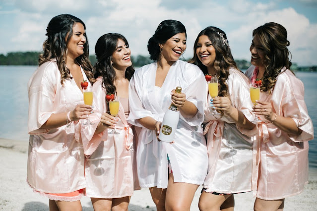 bride in robe with bridesmaids in pink robes