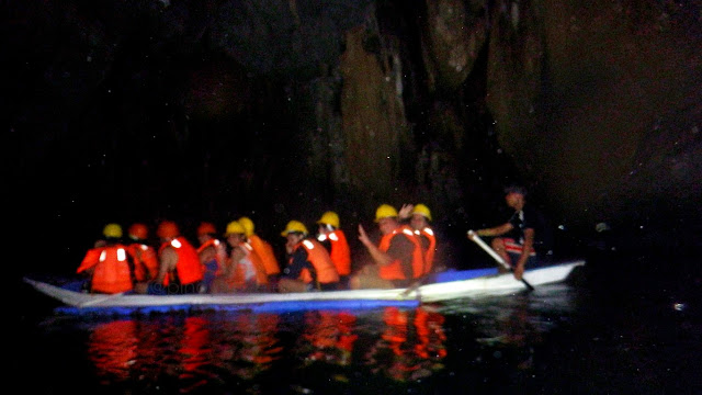 a boatload of tourists inside the St. Paul Cave and Underground River also known as Puerto Princesa Underground River