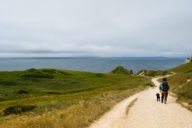 A woman walks her dog on Britain's Jurassic Coast with no one else in sight