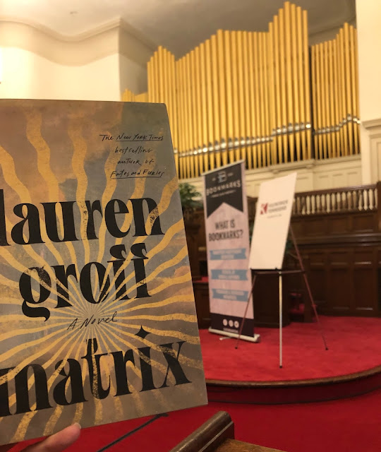 book help up in front of a church organ