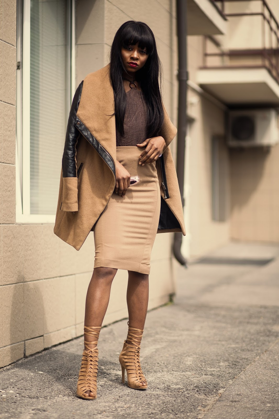 Brown fitted skirt paired with brown heels and a brown jacket