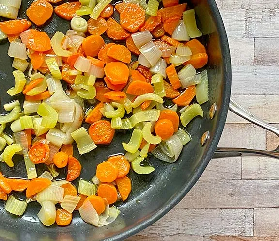 Carrots celery and shallots in a frying  pan