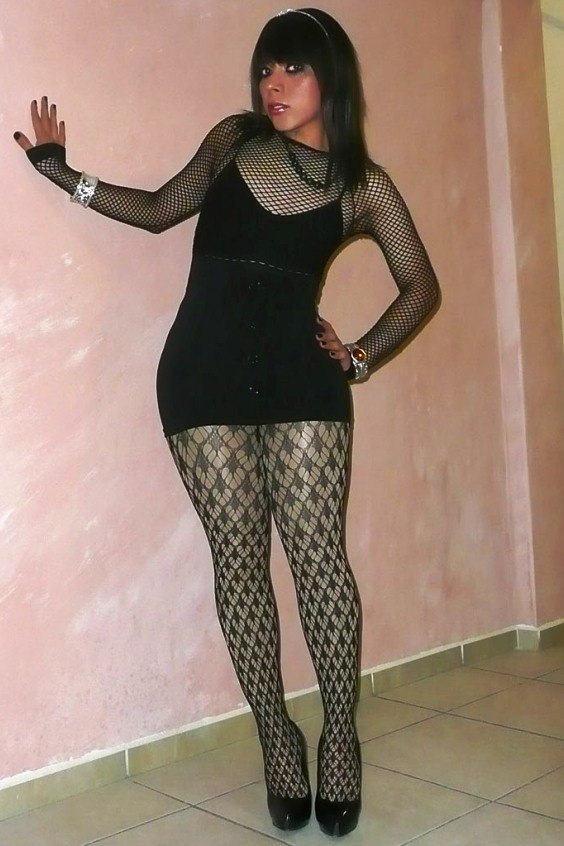 Beautiful crossdresser in black pantyhose and heels
