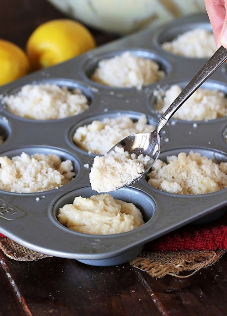 Sprinkling Crumbs Over Tops of Muffin Batter Image