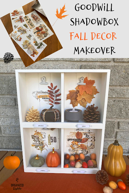 Photo of an upcycled thrifted shadowbox decorated with decor transfers and filled with fall mini decor.