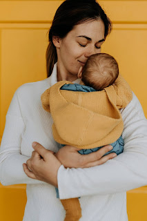 A mother burping her baby