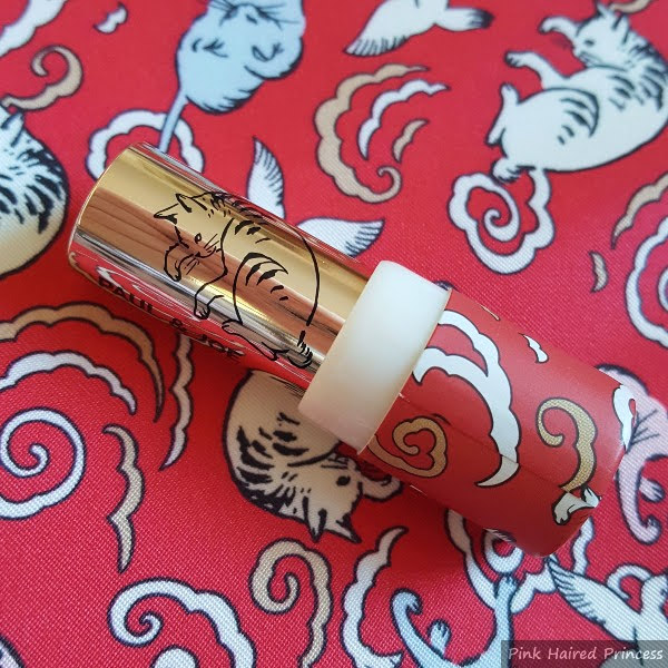 cat outline on metal part of lipstick and red case