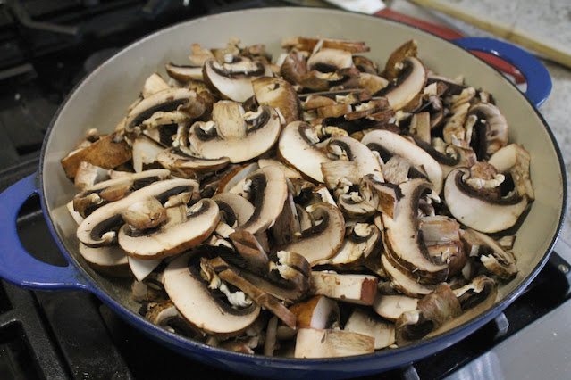 Adding the mushrooms to the butter pan.