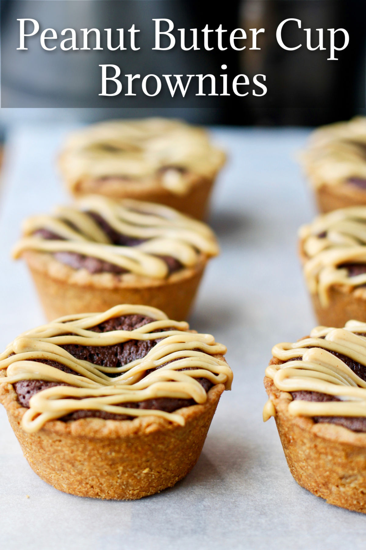 Peanut Butter Cup Brownies on plates with a peanut butter ganache drizzle.