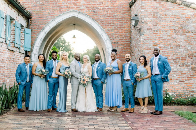 bride and groom with bridal party in blue