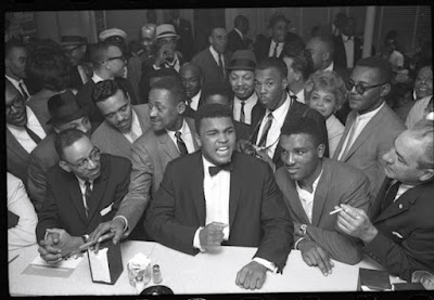 black and white photograph of Cassius Clay (Muhammad Ali) victory party after he defeated Sonny Liston for the Heavyweight Championship, February, 1964