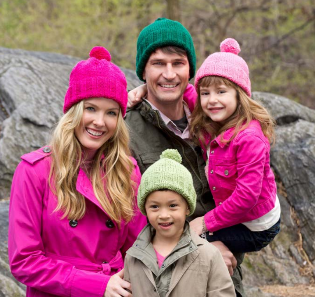 Image from Yarnspirations shows Man, Woman and two children wearing knit hats in various colors