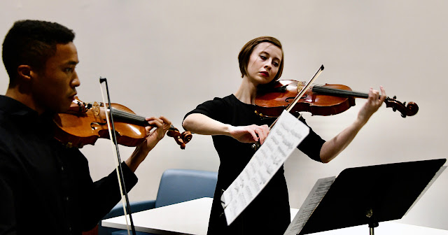 Uniformed Services University students Air Force 2nd Lt. Courtney O’Keefe and Army 2nd Lt. Brandon Hillery practice before the Apollo Society’s Winter Talent Show on Dec. 3.  The Apollo Society is a campus group that encourages students to  practice and perform music for their peers.