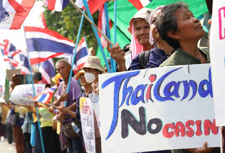 Thai protesters rally, flags waving, as nation debates casino legalization.