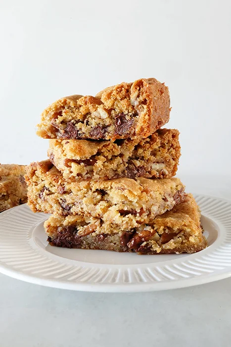 stack of chocolate chip pecan buttermilk cookie bars on plate