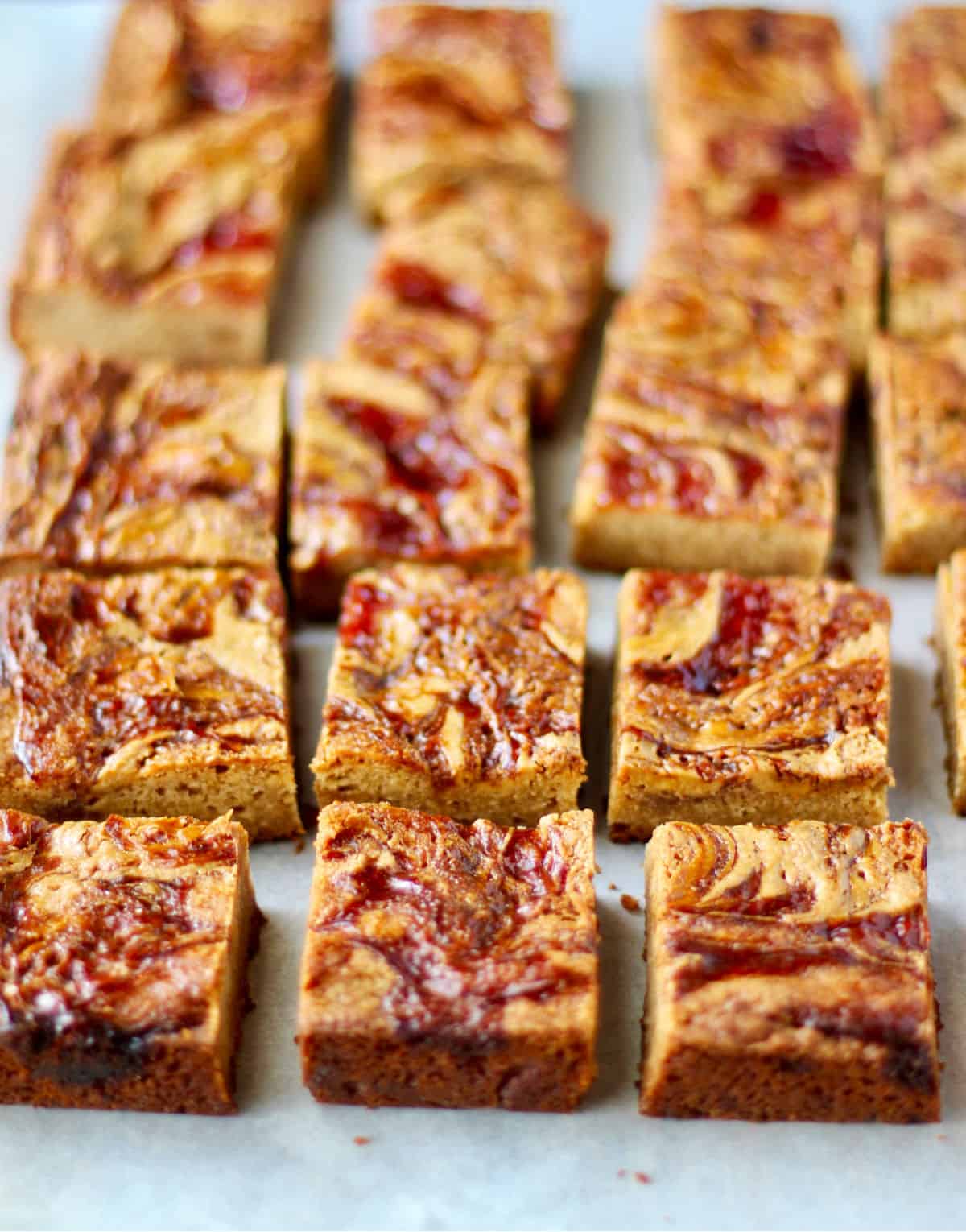 Peanut Butter and Jelly Blondies cut into bars.